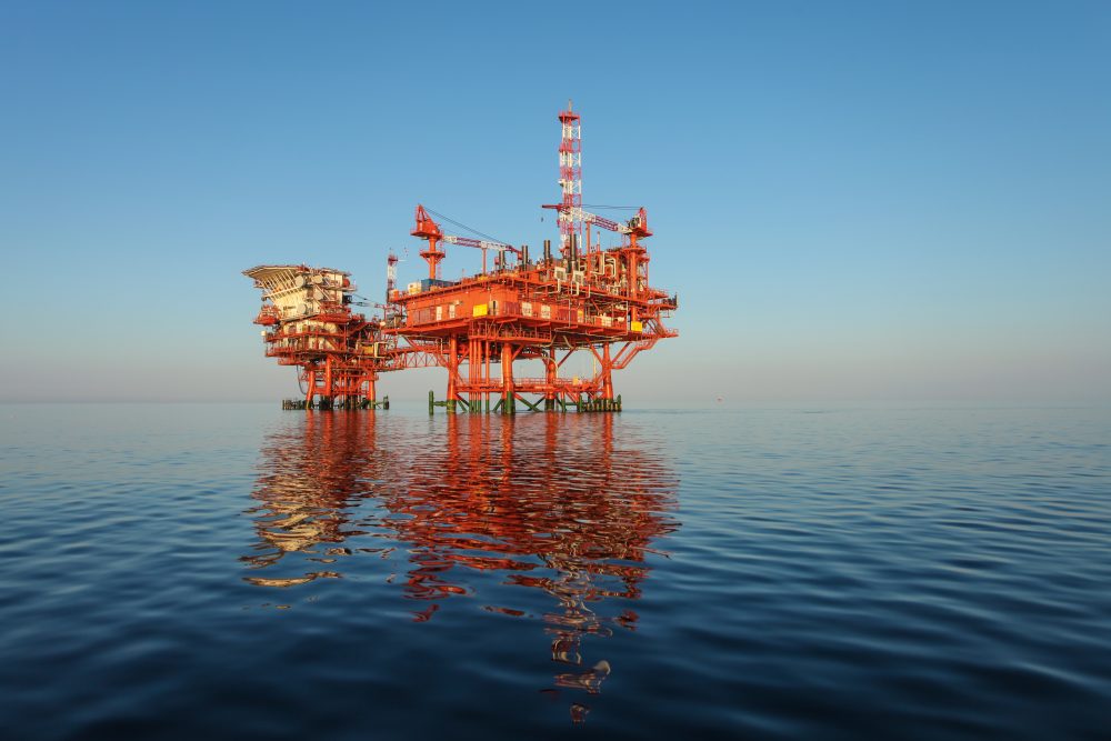 Red,Oil,Rig,Platform,On,Calm,Blue,Sea